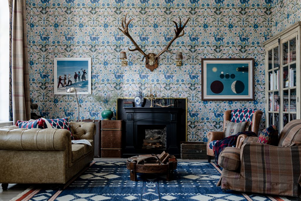 A highly decorative living room with patterned wallpaper and rug